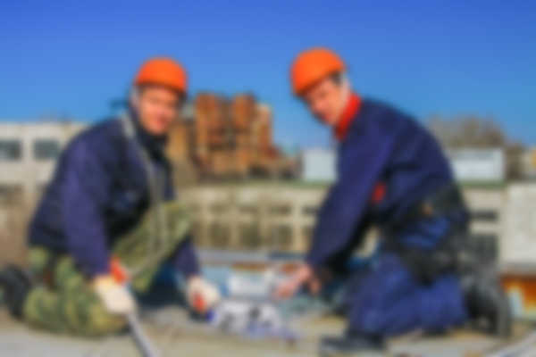 two contractors facing on roof facing camera