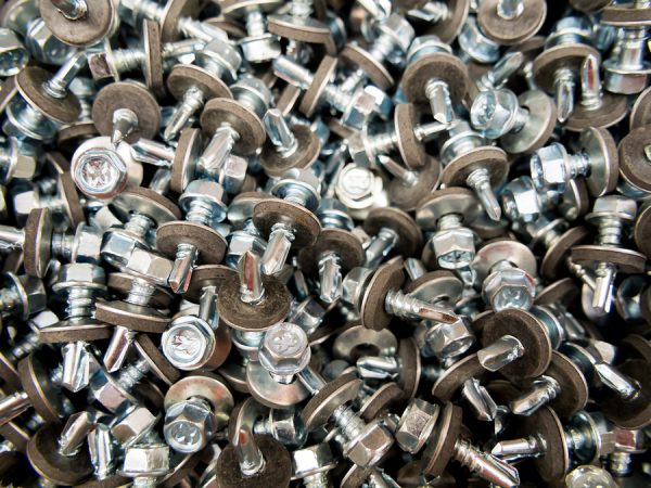 A scattering of roofing screws with a hexagon head